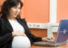 A pregnant woman working in the office