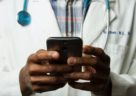 doctor reading notes on phone