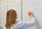woman writing on whiteboard