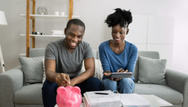 couple with piggy bank saving money