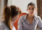 Indian businesswoman speaking to colleague or hr during job interview, young professional hindu woman manager consulting client or explaining giving advice teaching at business office meeting