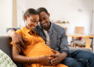 image expectant parents smiling before their parental leave