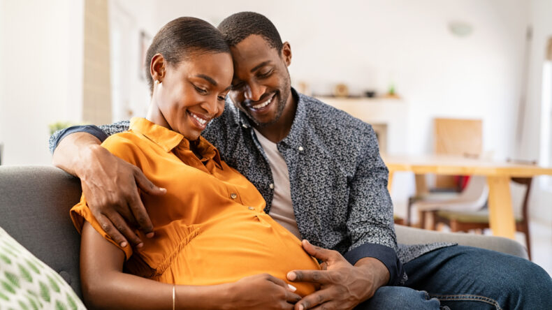 image expectant parents smiling before their parental leave