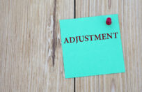 adjustment word written on note for payroll adjustment