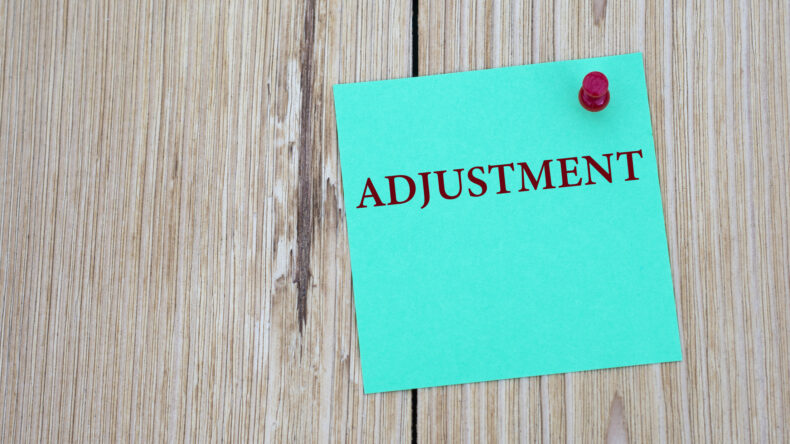 adjustment word written on note for payroll adjustment